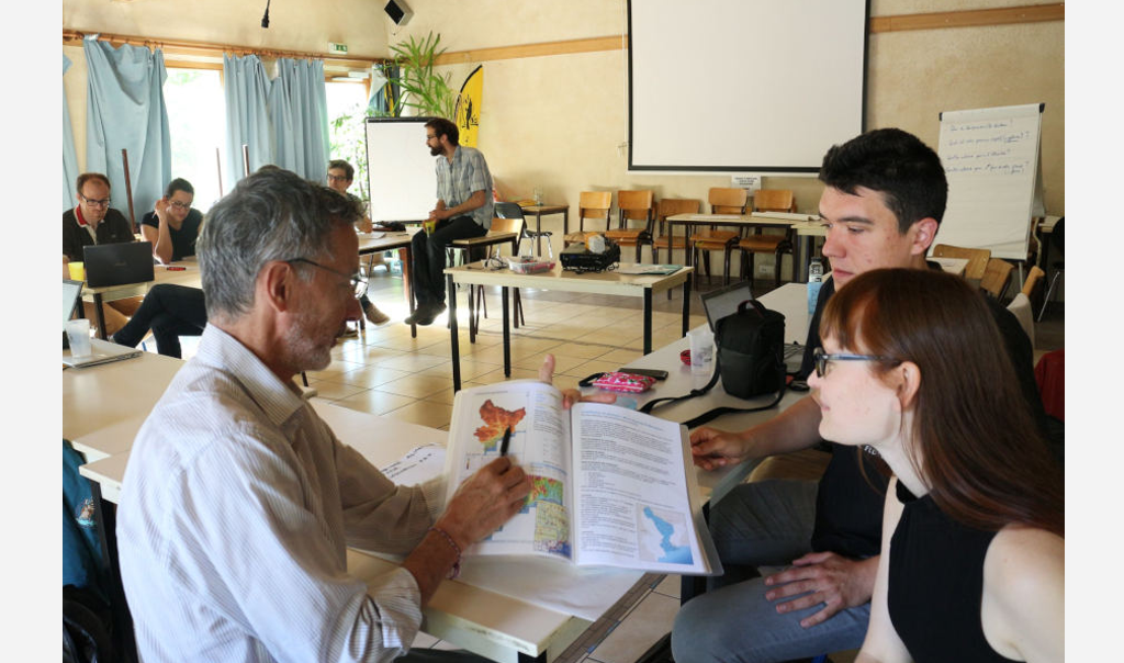 Personnes dans une salle de réunion travaillant en petits groupes